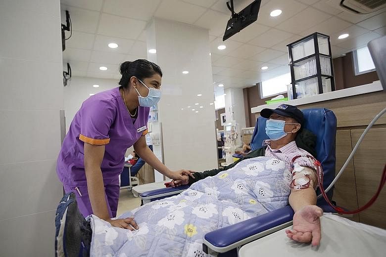 Ms Uma Rani, 34, a dialysis care associate at the National Kidney Foundation, chatting with Mr Chor Chen Sin, 71, during his treatment at the SCAL-NKF Dialysis Centre last week.