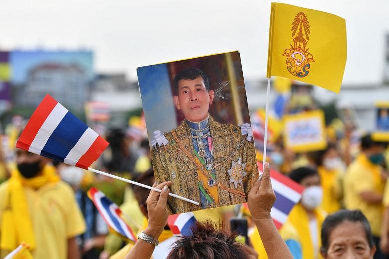 A royalist with a portrait of King Maha Vajiralongkorn during a rally in Bangkok on Wednesday. A German parliamentary source says the government believes that the Thai King is permitted to make occasional decisions while living in Germany. PHOTO: AGE