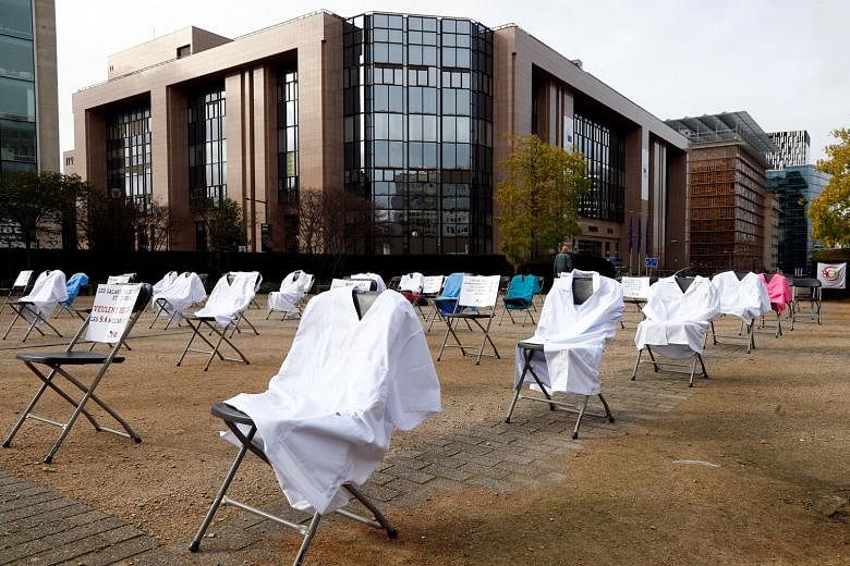 A protest site in Brussels with nurses' clothing draped over chairs in a symbolic action by the European Federation of Public Service Unions - which represents health and social service workers - to demand healthcare funding. PHOTO: REUTERS