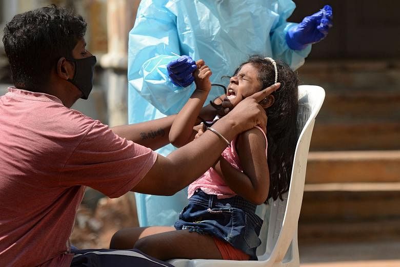 A girl being swabbed for Covid-19 at a centre in Hyderabad, Telangana, yesterday. India has one of the world's lowest death rates and the government has highlighted the slowing number of new infections in recent weeks. But Prime Minister Narendra Modi has