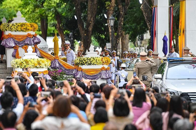 People taking photos as Thailand's King Maha Vajiralongkorn arrived to preside over a graduation ceremony at Thammasat University in Bangkok yesterday.