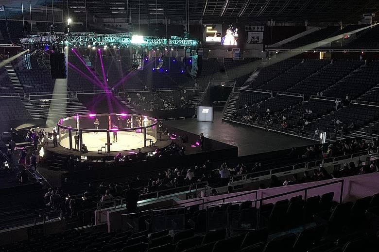 Some 250 spectators were seated apart at One Championship's Inside The Matrix event at the Singapore Indoor Stadium yesterday. The event is part of a pilot project that the Government hopes can pave the way for larger-scale ones to resume safely. Fan