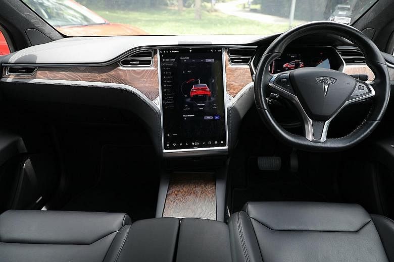 The Tesla Model X (above, left) and the Jaguar I-Pace (above, right). The Tesla Model X has a 17-inch portrait-style touchscreen, on which you can access a full suite of settings and ancillary controls. The Jaguar I-Pace's centre console retains phys