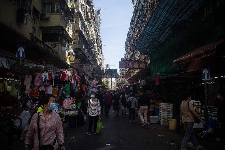 People in a street market in Hong Kong on Tuesday. Financial Secretary Paul Chan said if the flow of people and commerce between Hong Kong and mainland China is safely restored, the city can be "revitalised substantially" even if the global economy r