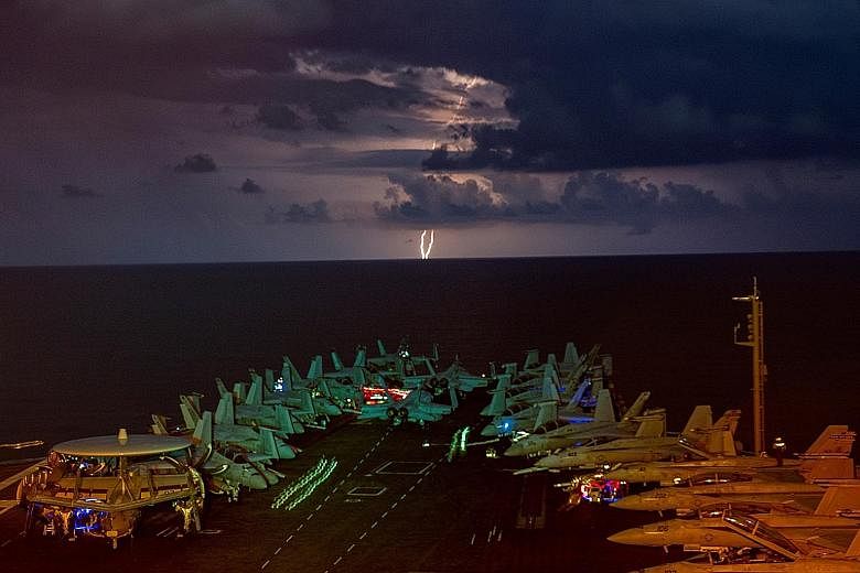 The USS Nimitz aircraft carrier in the South China Sea in July. The United States has rejected most of China's claims to contested waters there. PHOTO: REUTERS