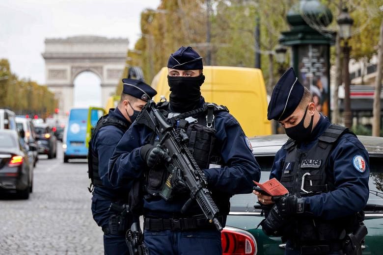 Police officers on the Champs-Elysees avenue in Paris yesterday, the first day of a national Covid-19 lockdown. President Emmanuel Macron has increased the number of soldiers mobilised from 3,000 to 7,000 to protect important sites such as places of 