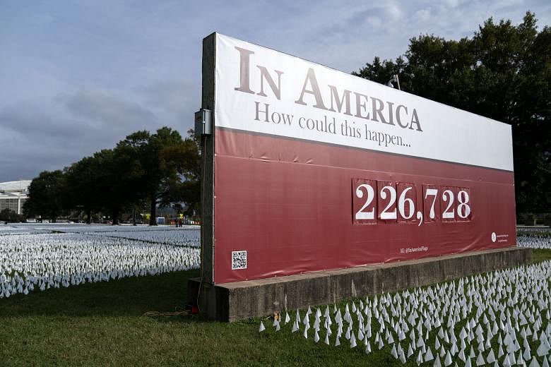 White flags representing the number of Americans who have died of Covid-19 at the DC Armoury parade grounds in Washington, DC, on Wednesday. More coronavirus cases have been identified in the United States than in any other country, though some natio