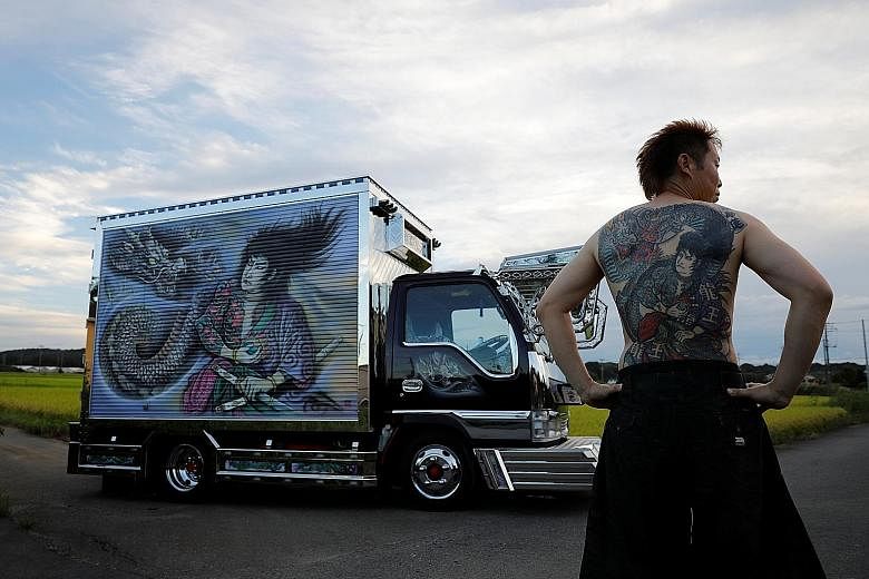 FASCINATION WITH INK:Mr Hideyuki Haga (above) with his truck, which is decorated with the same design as the tattoo on his back, in Saitama, Japan, in September. "When this painting was done, I think I was about as excited as when my tattoo was done.