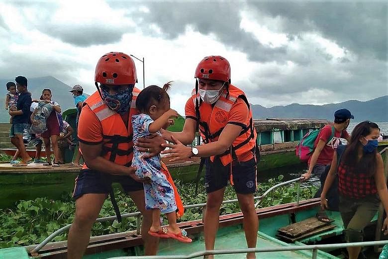 Philippine Coast Guard personnel evacuating residents yesterday from the coastal villages of Buhi town, Camarines Sur province, ahead of Typhoon Goni's landfall. PHOTO: AGENCE FRANCE-PRESSE