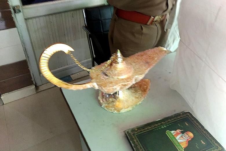 Police have arrested two men who allegedly duped a doctor into buying this lamp, and even conjured up a genie. PHOTO: AGENCE FRANCE-PRESSE