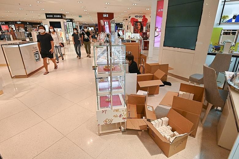 Shoppers inside the Robinsons outlet at Raffles City Shopping Centre yesterday. Some suppliers said they found out about the impending closure of the retailer's two branches only after they read the news, and that they did not get any advance word fr