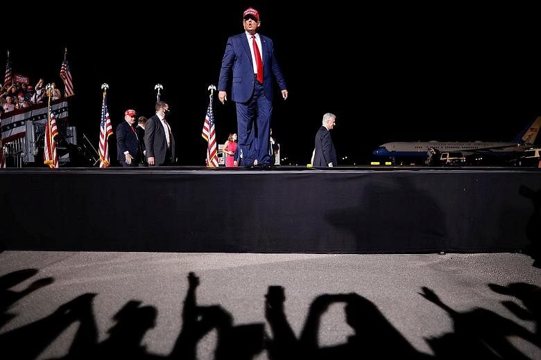 US President Donald Trump at a campaign rally yesterday in Opa-Locka, Florida. Some 24 hours before polls open today, his Democratic rival Joe Biden remained ahead of him across the country.