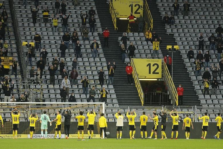 Dortmund players acknowledging their fans in the Signal Iduna Park's famed "Yellow Wall", which held a fraction of its 25,000 capacity when the team played Freiburg last month.