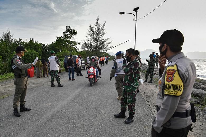 Indonesia has set up checkpoints to enforce mask regulations, among other measures, to curb the spread of Covid-19. The country is South-east Asia's worst-hit nation.