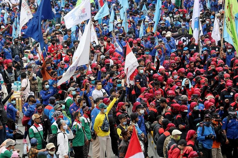Indonesian labourers taking part in a rally against the new law in Jakarta on Monday.