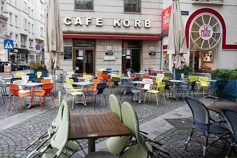 A shuttered restaurant in central Athens yesterday, after Greece announced a partial lockdown in the capital and other major cities.