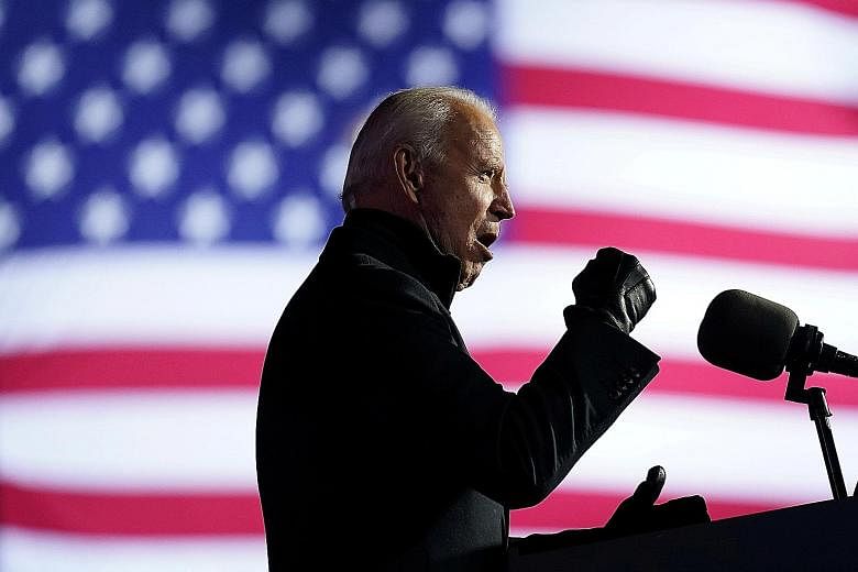Democratic presidential nominee Joe Biden at a drive-in campaign rally in Pittsburgh, Pennsylvania, on Monday. He had slammed Mr Donald Trump's divisive presidency and promised to get the pandemic under control. Mr Donald Trump after speaking at a ra