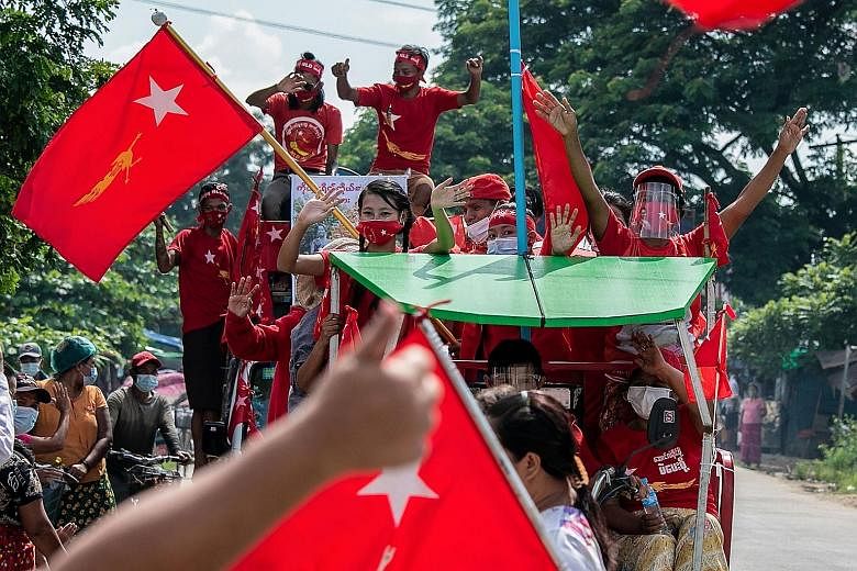 National League for Democracy party supporters (above) at a campaign rally in Yangon on Oct 25. The party's winning formula largely leans on the charisma and influence of party leader and state counsellor Aung San Suu Kyi (below) and its 2020 electio