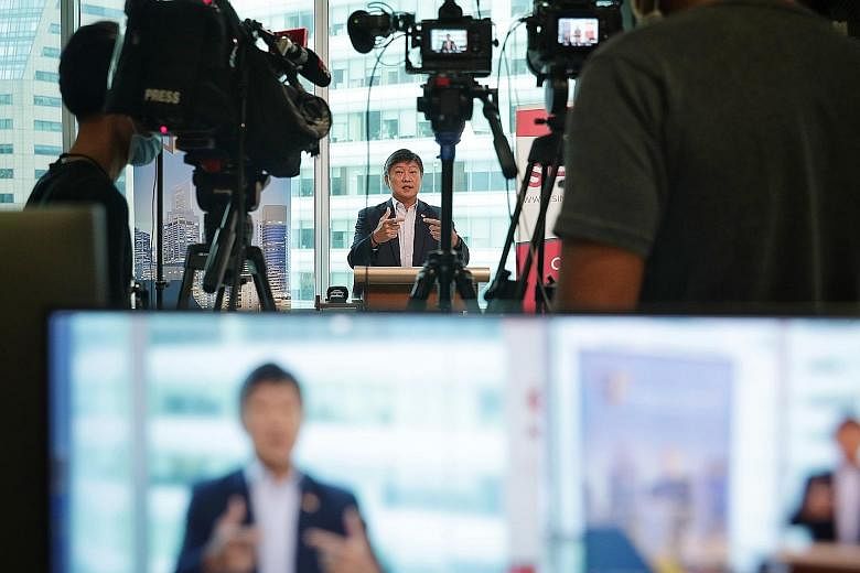 Labour chief Ng Chee Meng giving an address at the Digital Banking Symposium yesterday. He urged employers to redesign jobs where necessary and train workers, and also encouraged workers to keep an open mind and improve their skills to prepare for th