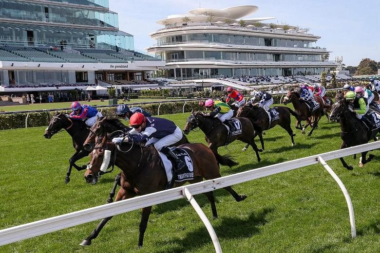 Eight-year-old gelding Twilight Payment heading to victory in front of empty grandstands in the Melbourne Cup yesterday. PHOTO: AGENCE FRANCE-PRESSE
