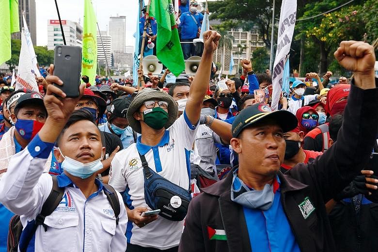 Indonesian trade union members protesting in Jakarta on Monday against the government's Job Creation Law. It was passed in Parliament on Oct 5 and signed off by President Joko Widodo on Monday. PHOTO: REUTERS