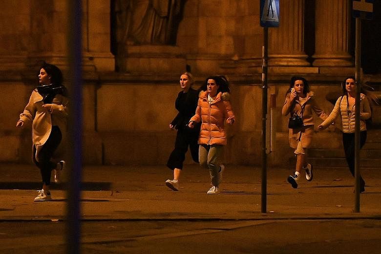 Police body-searching a man at Mariahilfer Strasse in central Vienna on Monday, following the shooting near a synagogue. PHOTO: AGENCE FRANCE-PRESSE People running away from the area near the Vienna State Opera in the city centre on Monday, following