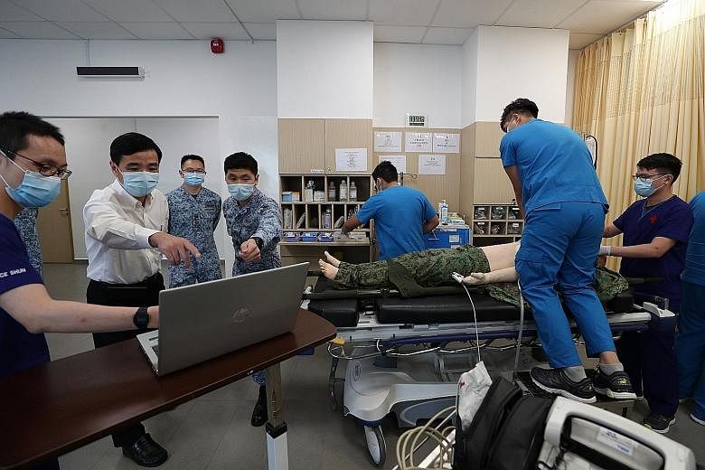 Senior Minister of State for Defence Heng Chee How (in white) at a demonstration of cardiopulmonary resuscitation to be administered during an emergency at the new Tengah Air Base medical centre.