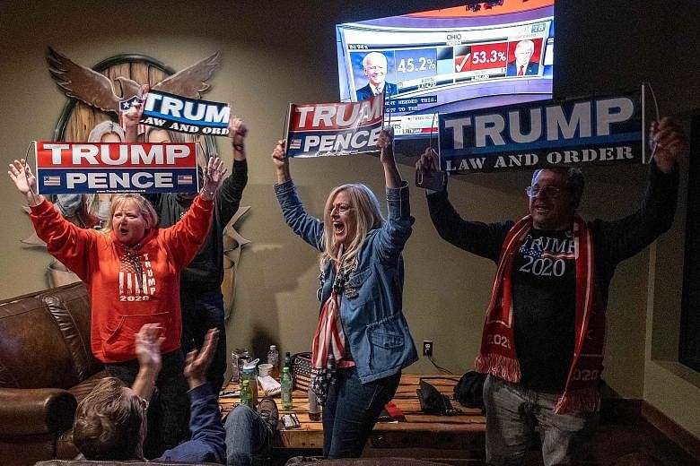 Right: Supporters of United States President Donald Trump celebrating his win in Ohio at a Republican watch party in New Hudson, Michigan on Tuesday. Far right: Supporters at a drive-in election night event for Democratic presidential nominee Joe Bid