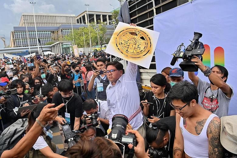 A protester holding up an image of a pro-democracy commemorative plaque at a rally in Bangkok in September. Official propaganda has long portrayed the mandate of Thailand's kings as divine. Now protesters are appropriating symbolism connected with ro