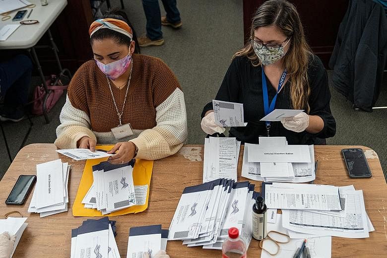 Above: Ballots being sorted in Wilkes-Barre, Pennsylvania. The battle for the state, which may yet decide the outcome of the election, hinges on mail-in ballots which favour Democratic candidate Joe Biden. Left: Election workers at a kerbside voting 