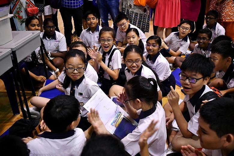 Pupils reacting to the release of PSLE results at Geylang Methodist School (Primary) in 2018. The indicative cut-off points under the new scoring system show that one may not need to get a perfect achievement level score of four for admission to popu