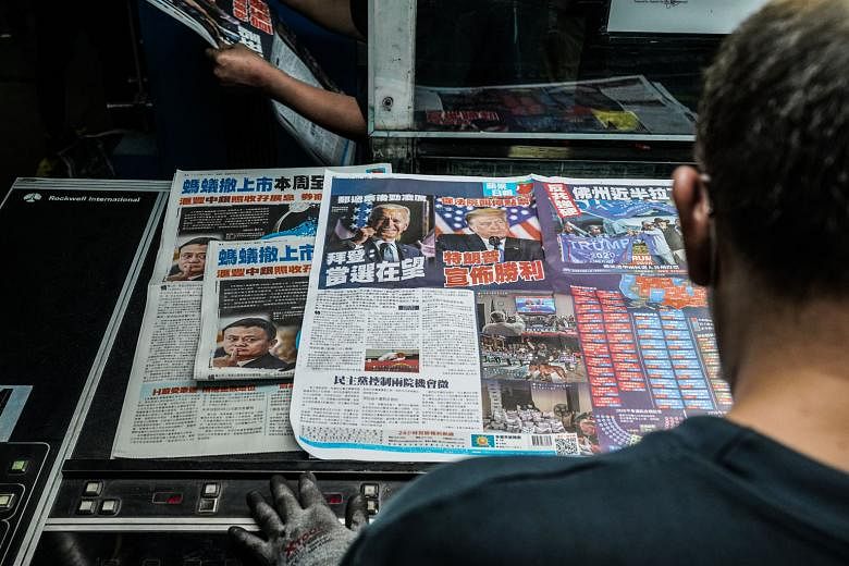 Pages of the Apple Daily newspaper - with coverage of the US presidential election - being inspected at a printing facility in Hong Kong on Thursday, even as the race outcome hung in the balance.