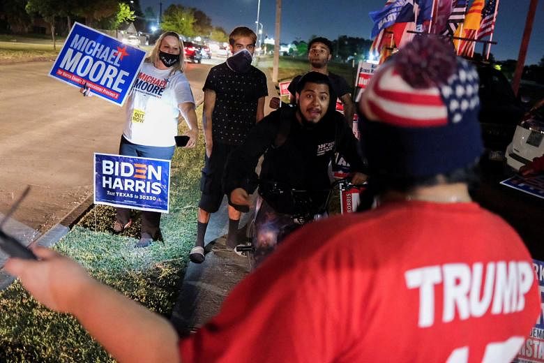 Supporters of Mr Joe Biden and Mr Michael Moore, a Democrat who was running in a county election in Texas, in a face-off with pro-Trump supporters outside a polling site in Houston on election night on Tuesday. PHOTO: REUTERS