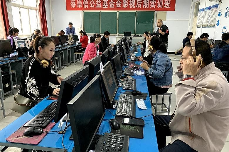 (Top) Primary 1 pupils in Luanping reciting poetry in class. Schools there emphasise cultivating perfect pronunciation in young children. (Above) People taking a test for Mandarin pronunciation in Luanping. The authorities require teachers, state ent