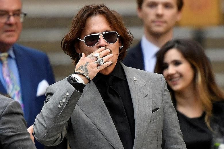 Actor Johnny Depp leaving the High Court in London on July 28 after his libel trial against The Sun newspaper. He had sued the publishers of the tabloid after it said he had been violent towards his former wife, actress Amber Heard. PHOTO: REUTERS
