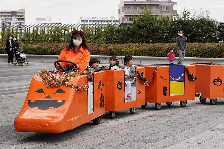 Children in a Halloween-themed fun train in Tokyo on Oct 30. Japan's Health Ministry has estimated that there will likely be 845,000 newborns this year, 20,000 fewer than last year which was also the fifth straight year of decline. The government has