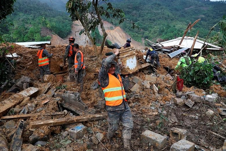 Soldiers removing mud and debris from an area hit by a mudslide, caused by heavy rain brought by Storm Eta, as they searched for victims in the buried village of Queja, in Alta Verapaz, Guatemala, last Saturday. Fresh landslides later in the day halt