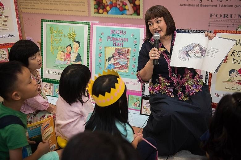 Author Debra Ann Francisco reading at her book launch in 2018. The former teacher has written five books that teach kids about Singapore's diverse food culture.