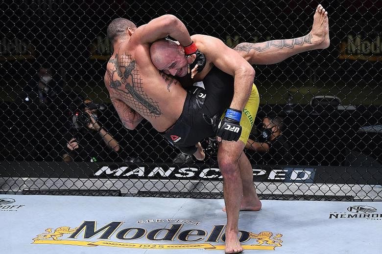 Glover Teixeira (yellow shorts) wants a title fight for the first time in over six years, after submitting Brazilian compatriot Thiago Santos via a rear-naked choke in the main event of UFC Fight Night in Las Vegas on Saturday. The 41-year-old came b