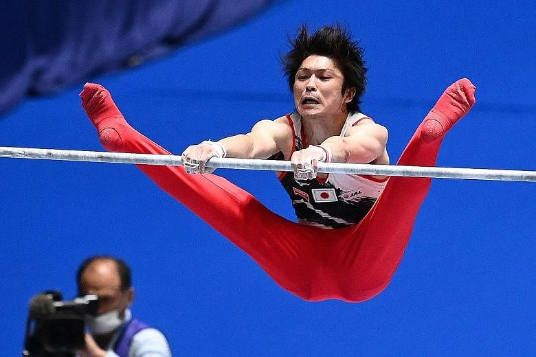 Left: Kohei Uchimura thrilling the crowd in Tokyo's Yoyogi National Gymnasium on the horizontal bar in yesterday's Friendship and Solidarity Competition. For the Olympic champion, it was "just plain fun" to compete after two years of injury. Below: M