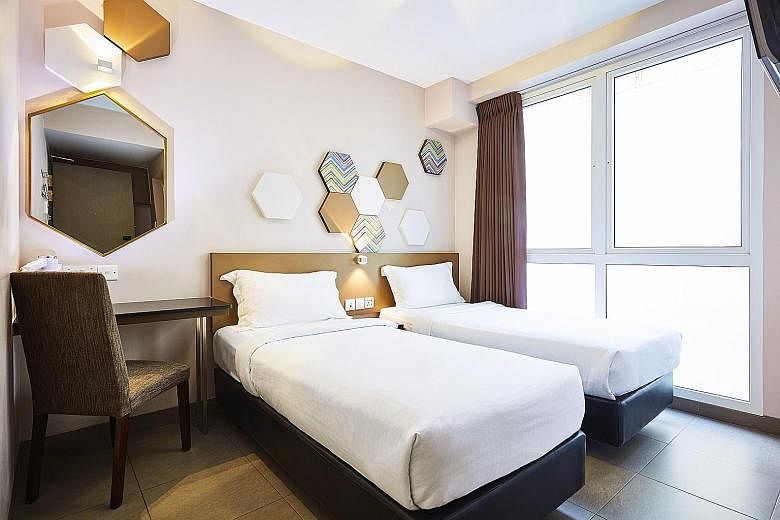 Neutral cream and beige tones dominate the rooms (left) in the new Ibis Budget Singapore Imperial in Lavender.