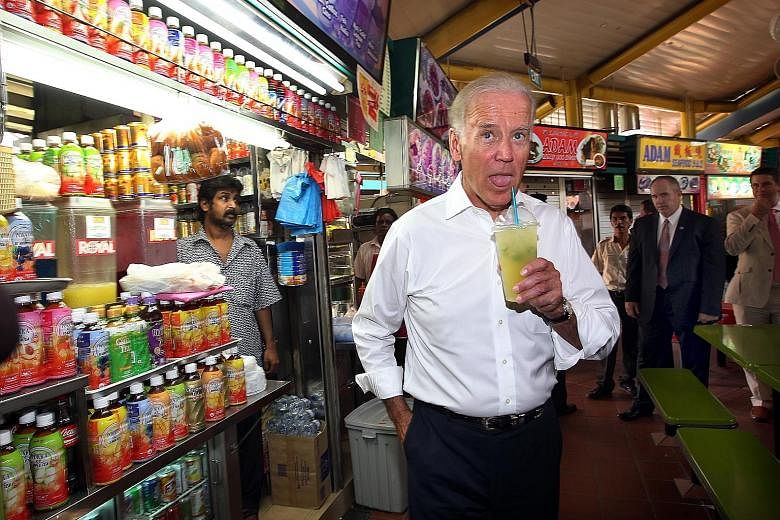 Mr Joe Biden having a cup of ice-cold lime juice during a surprise visit to the Adam Road hawker centre while on his first official trip to Singapore as US vice-president in July 2013.