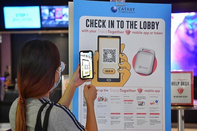 A moviegoer using the TraceTogether app to scan a QR code to check in at a Cathay cinema on Oct 31. Most users are not conscious of the dangers associated with QR codes, but the app is able to validate them. ST PHOTO: CHONG JUN LIANG
