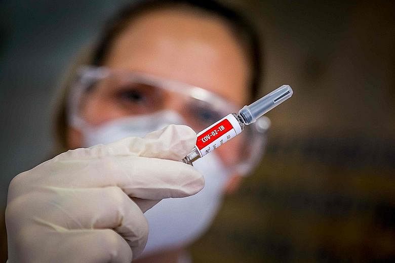 A nurse at Sao Lucas Hospital in Porto Alegre, Brazil, holding a vial of Covid-19 vaccine made by Chinese firm Sinovac Biotech. Brazil's national health regulator yesterday allowed clinical trials of Sinovac's vaccine to resume, two days after an "ad