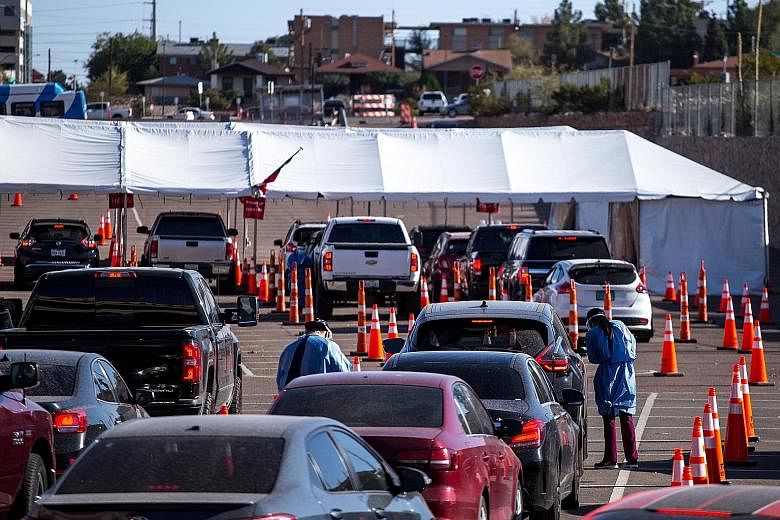Medical experts reckon that for the initial administering of coronavirus vaccines, Americans will have to go to hospitals or big distribution centres set up in parking lots, much like this Covid-19 test site in El Paso, Texas. PHOTO: BLOOMBERG