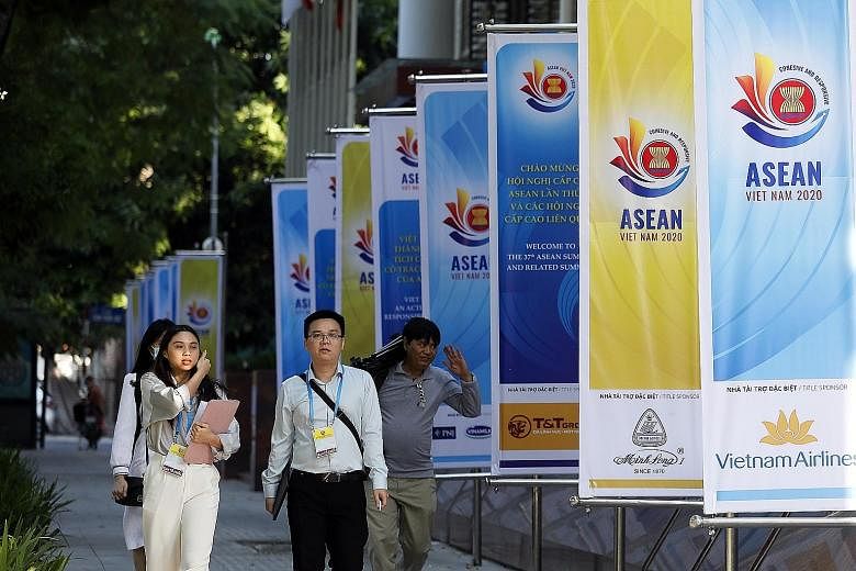 Banners promoting this week's Asean Summit line the street in Hanoi, Vietnam. Regional leaders will meet virtually and focus on an agenda that includes the completion of the Regional Comprehensive Economic Partnership deal and the launch of the regio