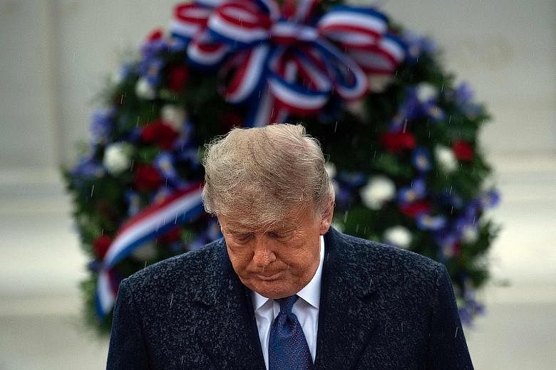 US President Donald Trump leaving Arlington National Cemetery in Virginia after placing a wreath at the Tomb of the Unknown Soldier on Veterans Day yesterday. PHOTO: AGENCE FRANCE-PRESSE