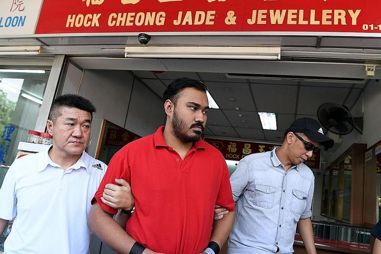 M. Jegatheesh was brought back to Hock Cheong Jade and Jewellery shop by the police on Aug 21 last year. He was jailed for three years and three months and sentenced to six strokes of the cane yesterday for his role in the robbery on Aug 14 last year