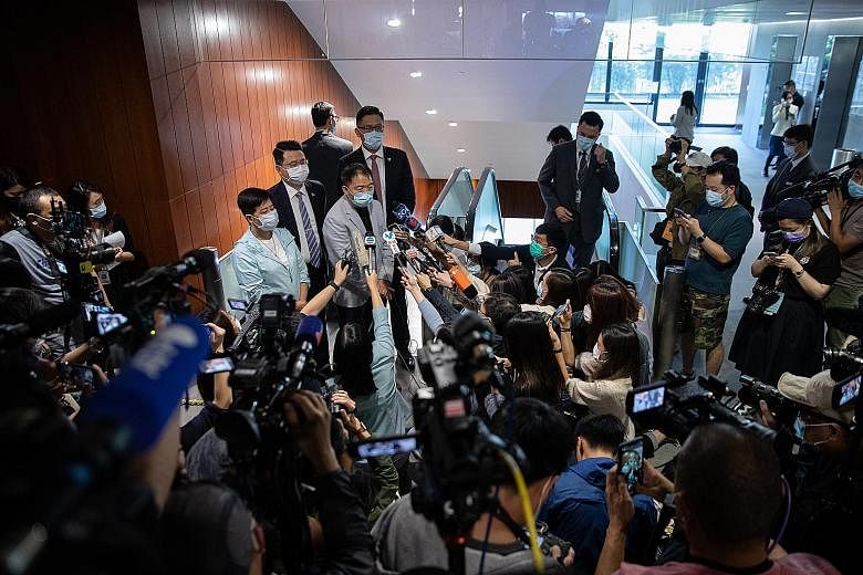 Pro-democracy lawmakers Helena Wong (from left), Andrew Wan, Wu Chi-wai and Lam Cheuk-ting speaking to reporters after tendering letters of resignation at the Legislative Council in Hong Kong yesterday. They are among legislators who quit in protest 