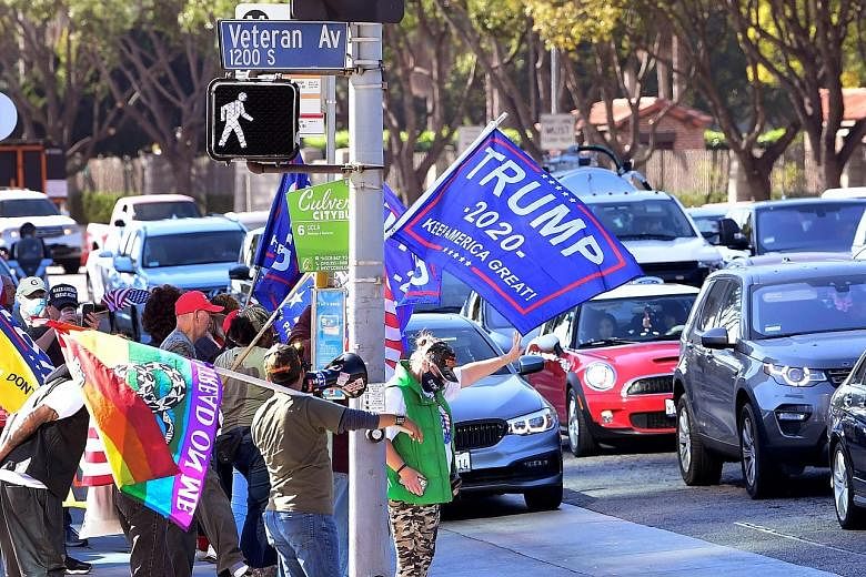 President Donald Trump's supporters in Los Angeles on Wednesday. Mr Trump's refusal to allow access to secure communications is creating risks in President-elect Joe Biden's dealings with foreign leaders.